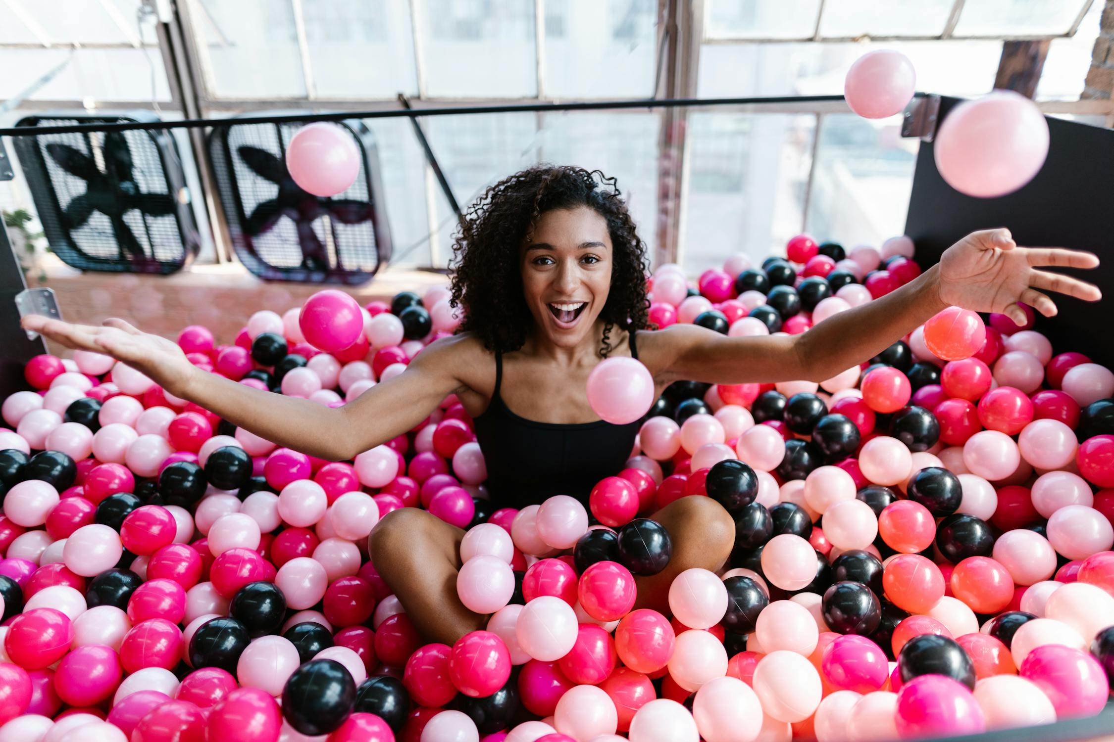 Excited woman in ball pit
