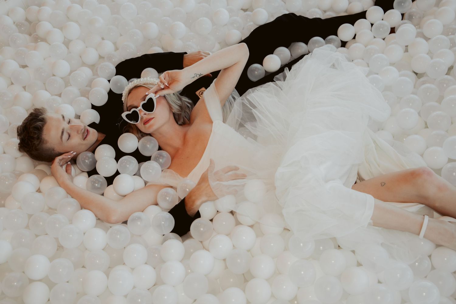 Wedding couple in white ball pit